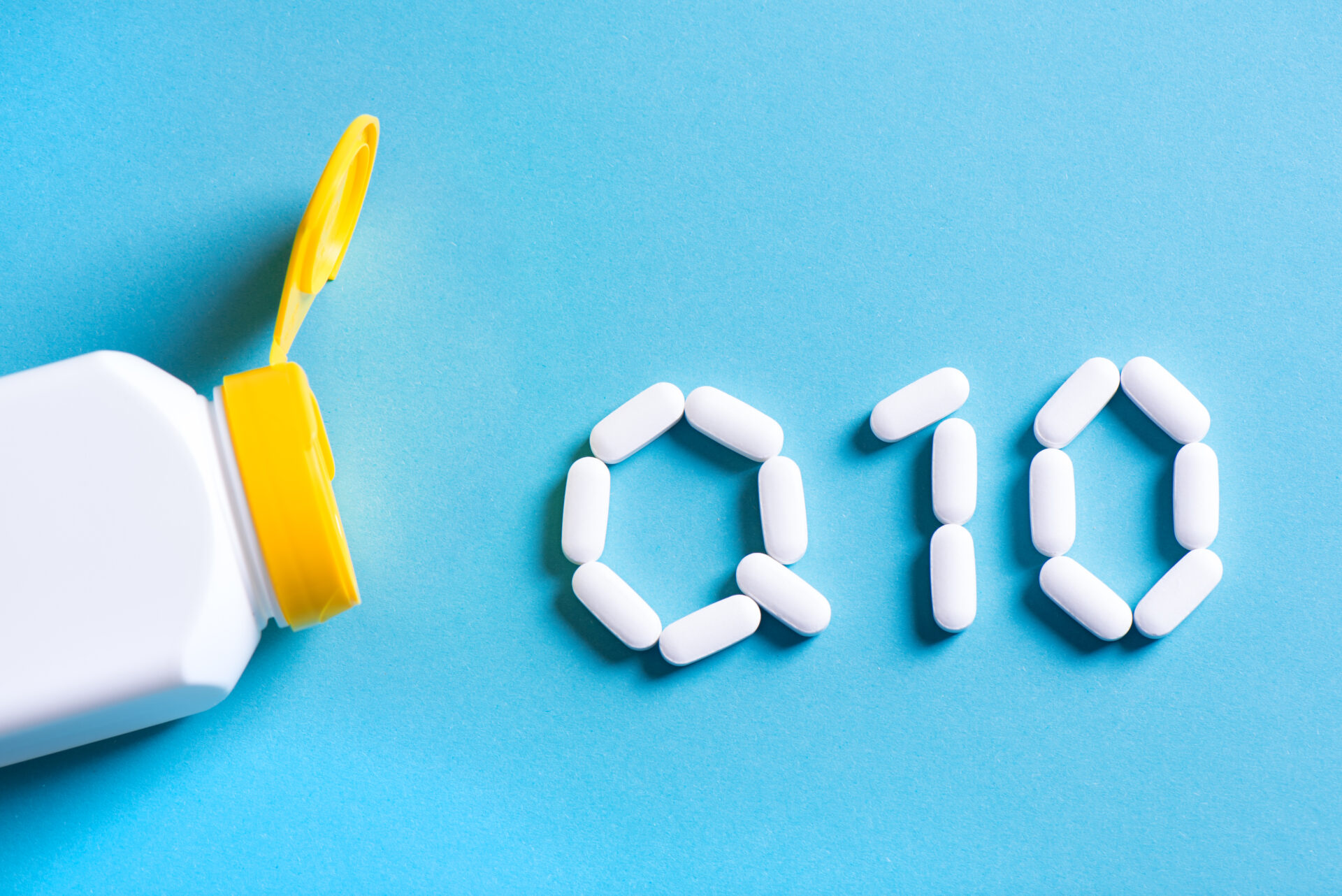 Coenzyme Q10 Supplement on Blue Background, Health Support Concept, Nutritional Supplement Coenzyme Q10, CoQ10, Heart Health Booster, Antioxidant Protection.