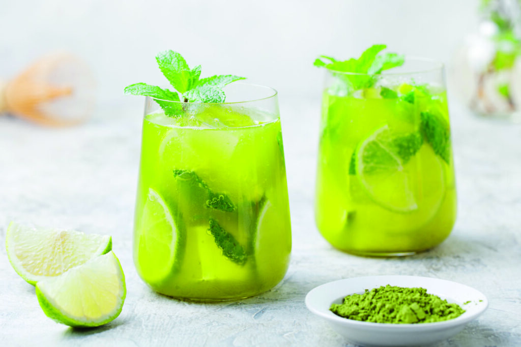 Matcha iced green tea with lime and fresh mint on a marble background